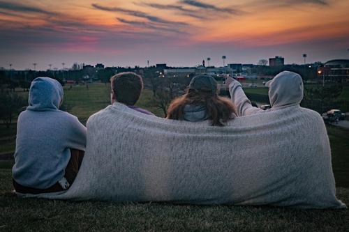 Four students watching the sunset
